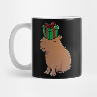 Capybara with a Christmas present on its head Mug